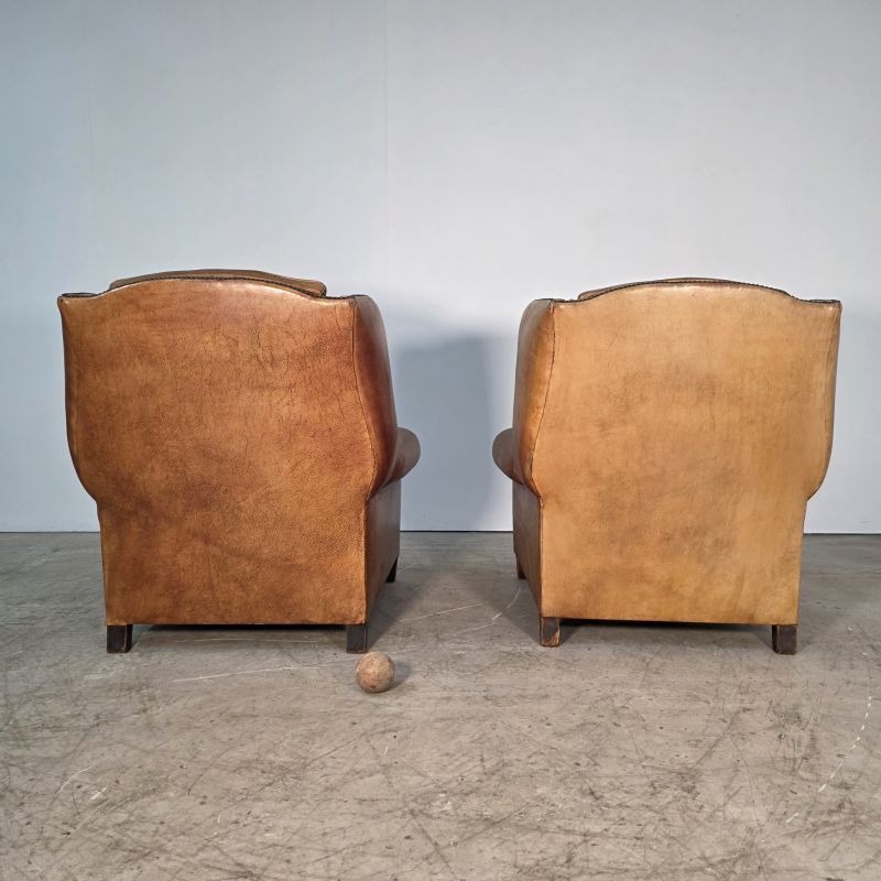 Beautiful pair of wide leather club armchairs with ears in Havana colour.