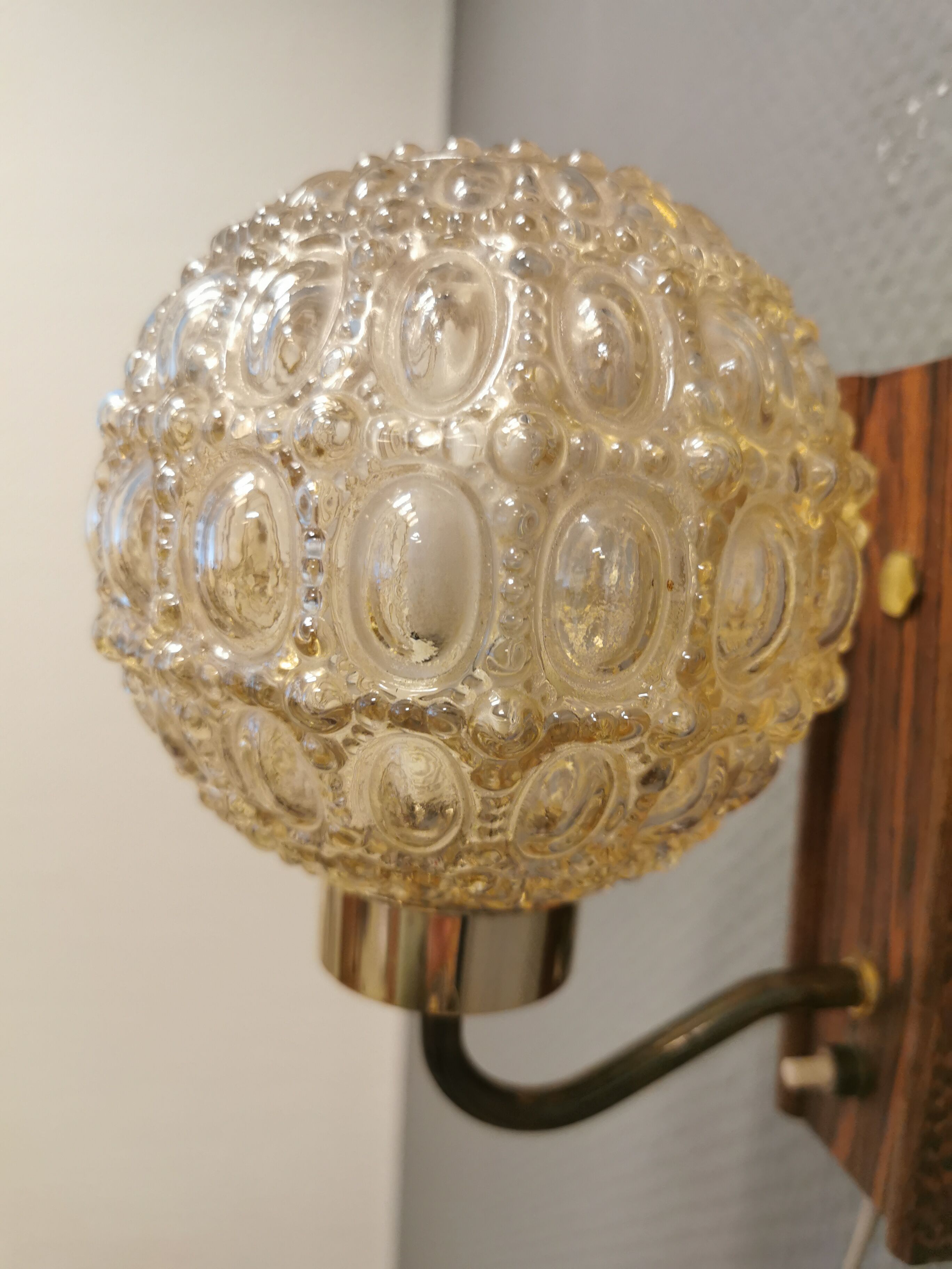 Wall light in rosewood with bobble glass ball shade.