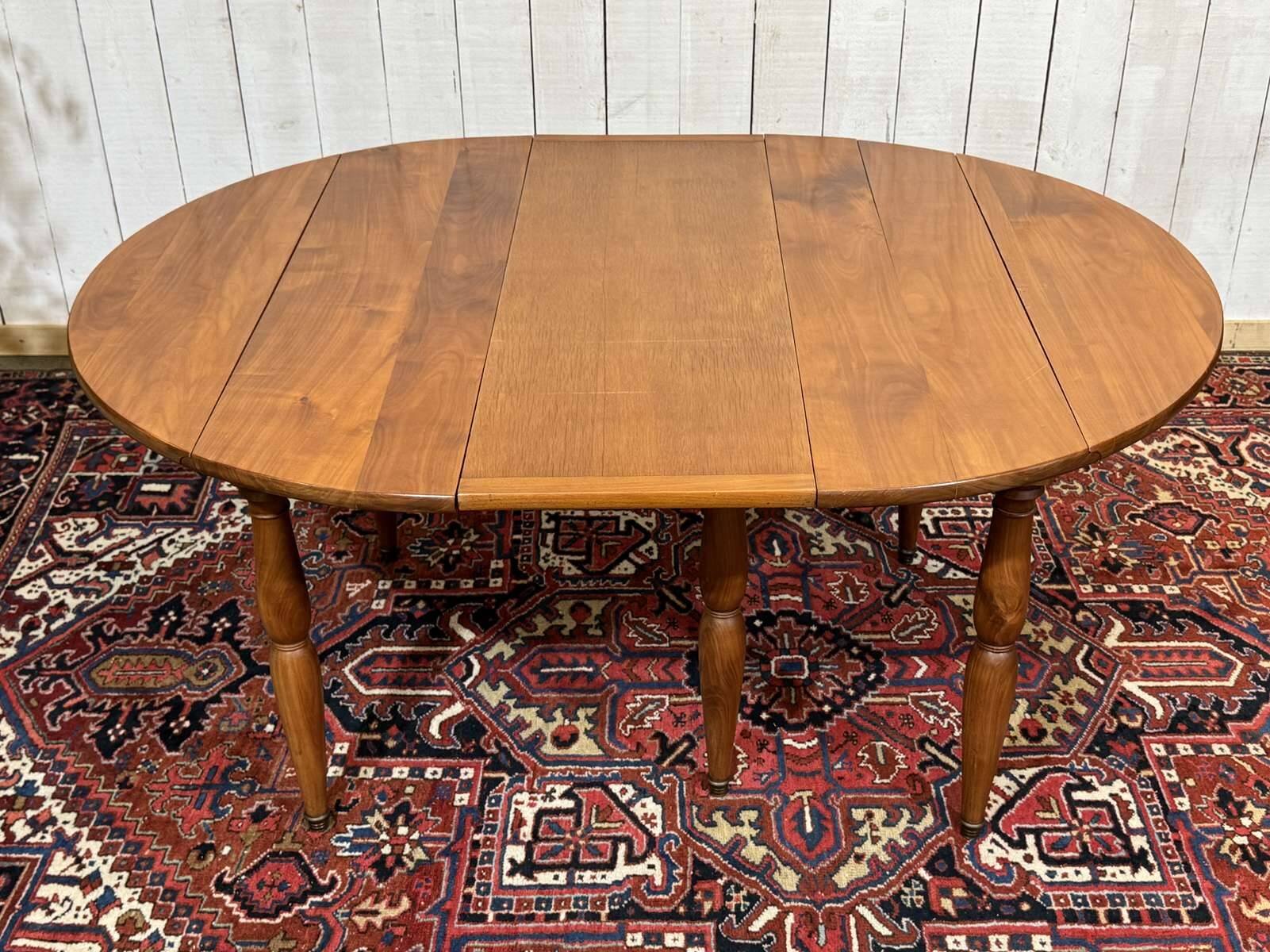 Round cherry wood table, 6 feet, Louis Philippe style with 2 extensions.