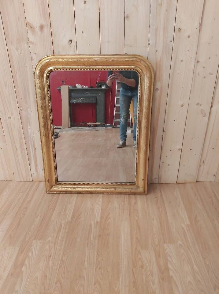 Golden Louis Philippe mirror with golden leafy