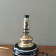 Vintage 70s lamp base in black and gold metal.