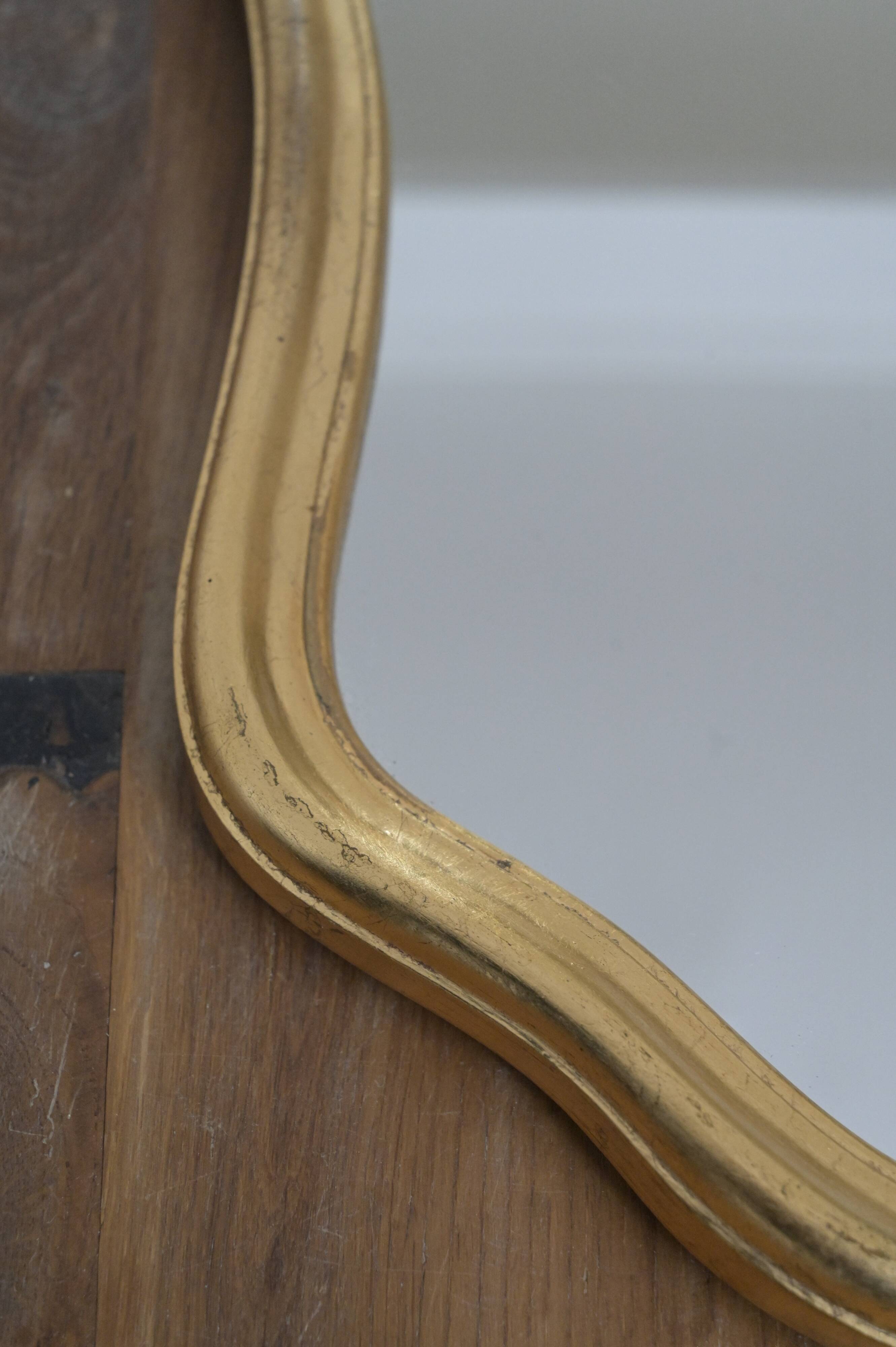 Golden mirror in wood and gold leaf