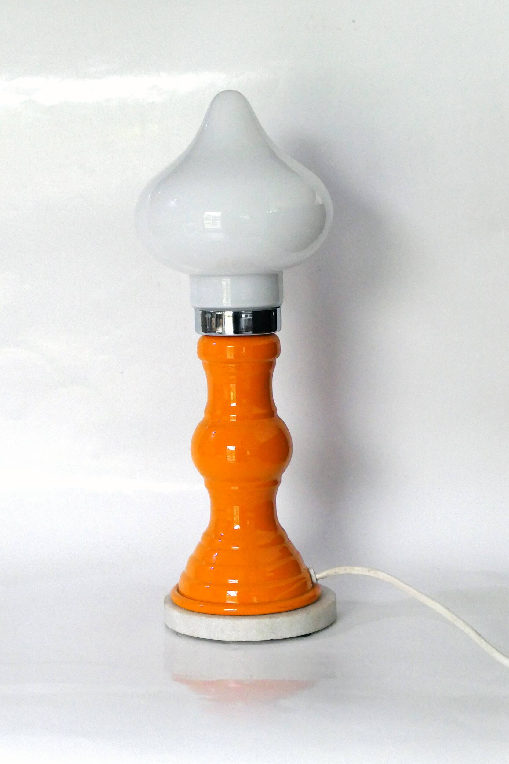 Table lamp or bedside lamp from the 1960s-70s in orange and chrome.