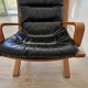 Scandinavian armchair in wood and leather.