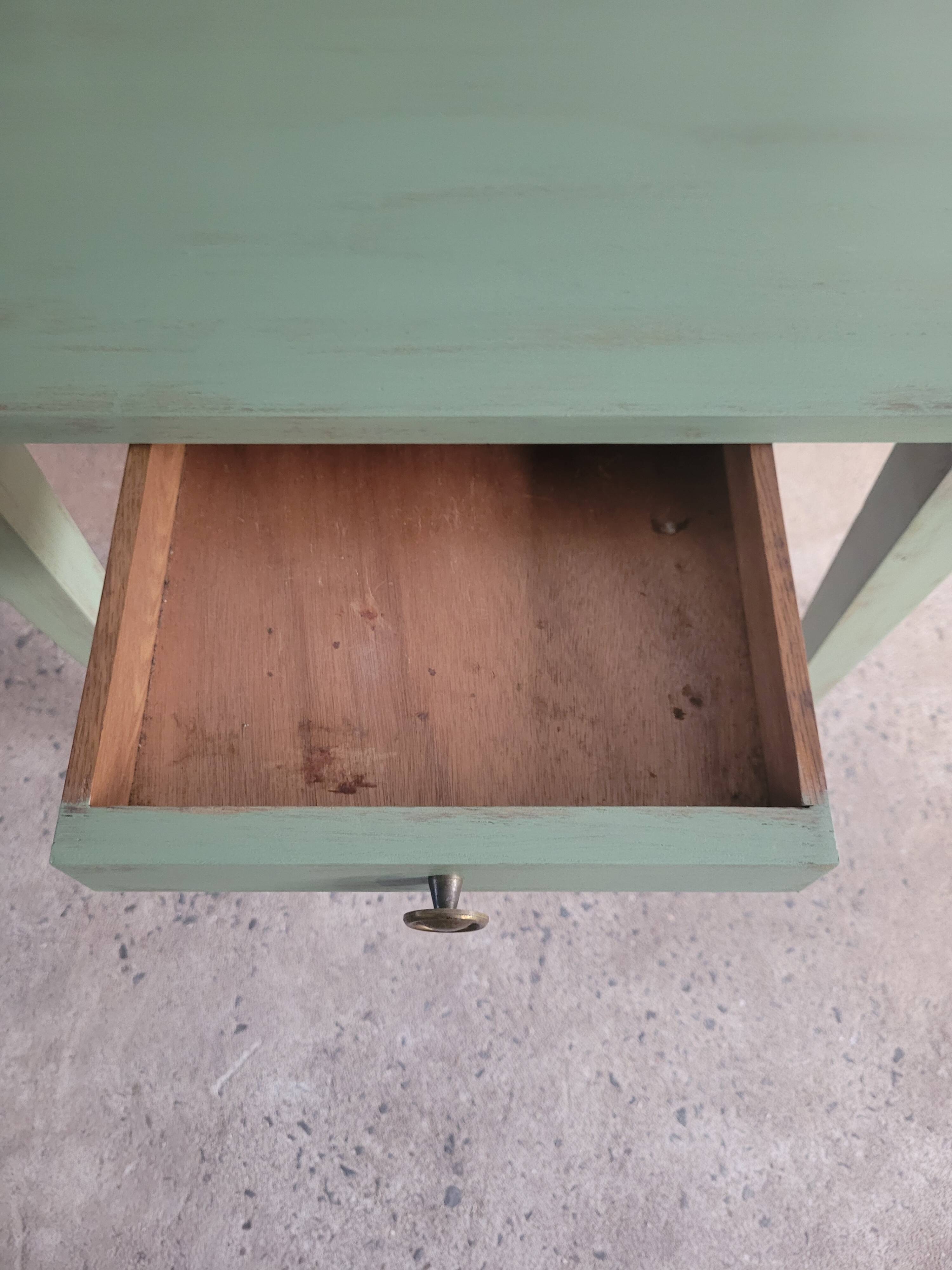 Green side table with tapered legs