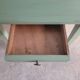 Green side table with tapered legs