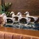 Four silver-plated napkin rings in the shape of a duck/goose