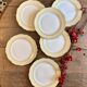 Set of 6 vintage white dinner plates with yellow and gold trim.