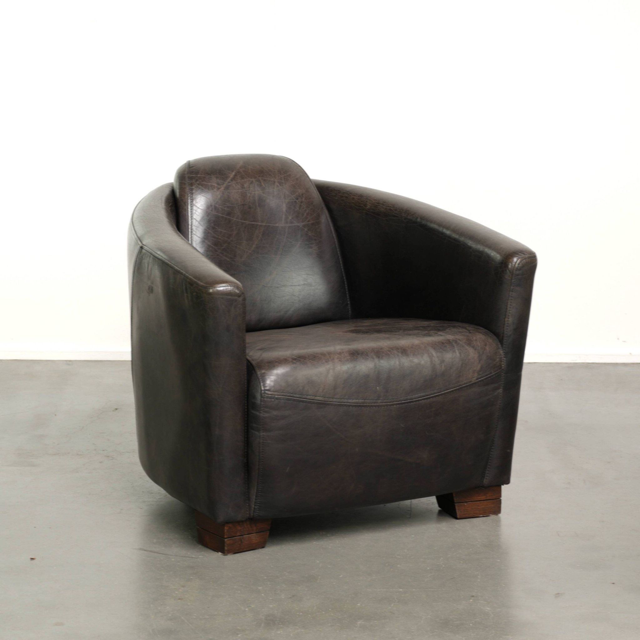 Cow leather Aviator design armchair in a dark colour scheme