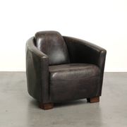 Cow leather Aviator design armchair in a dark colour scheme