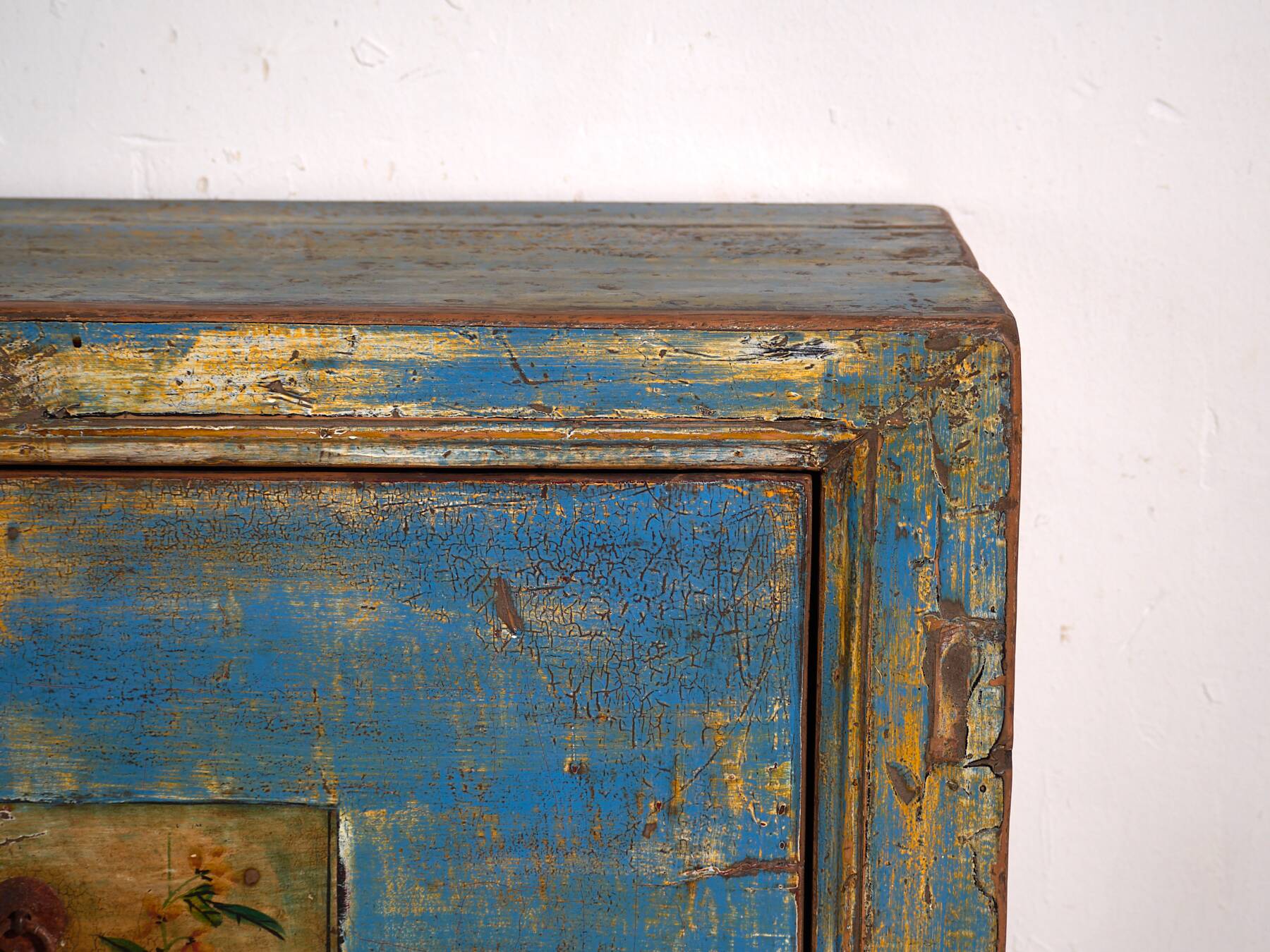 Old wooden entrance buffet in blue and yellow tones (circa 1920).