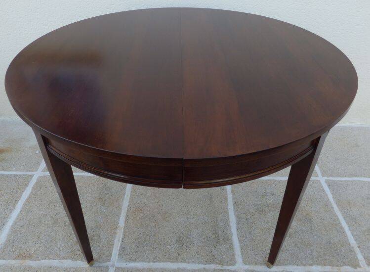 Round mahogany table with mahogany veneer and brass sabot foot.