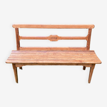 Old wooden bench with backrest, dated 1923