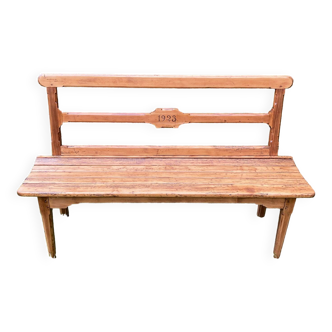 Old wooden bench with backrest, dated 1923