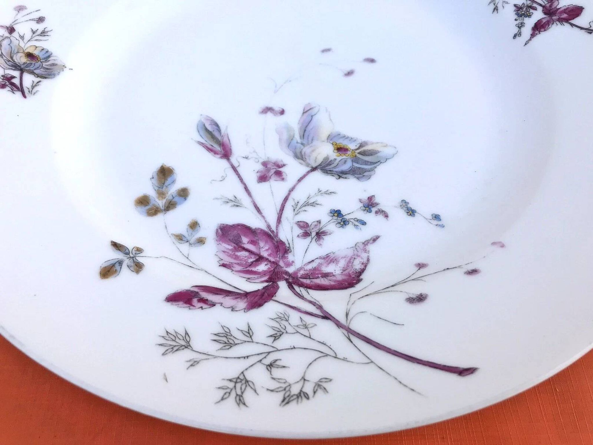 Antique white porcelain shallow dish with floral decoration.