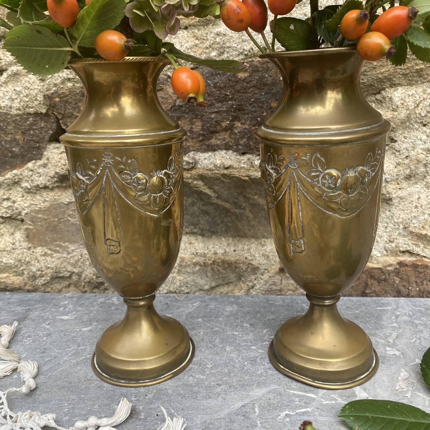 Pair of embossed brass bud vases stamped 17 cm