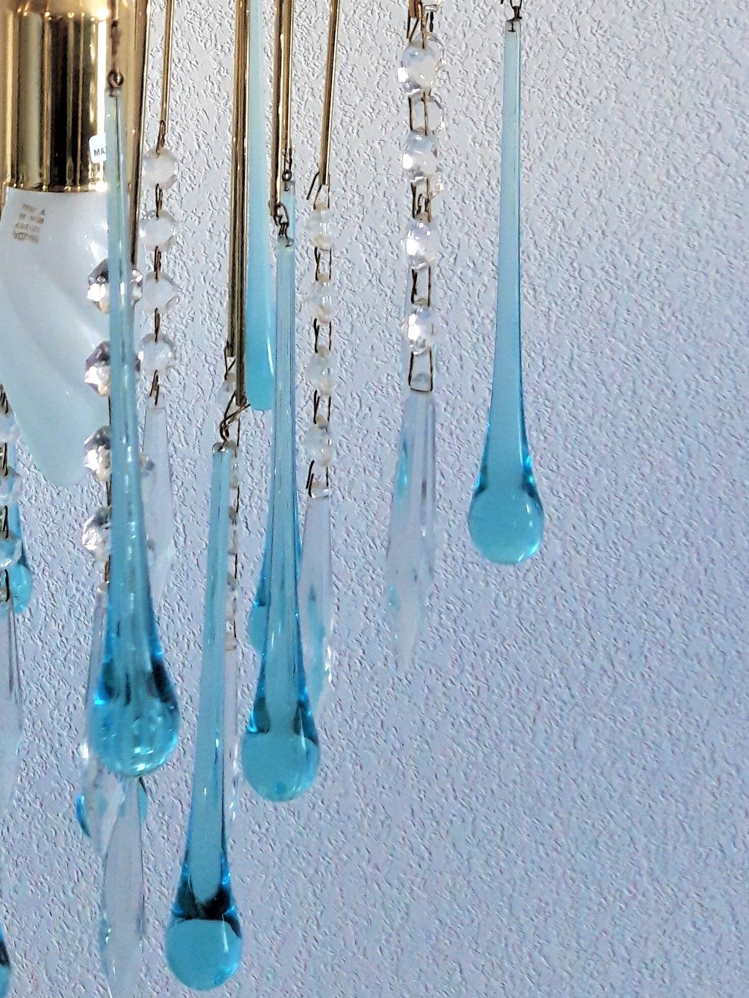 An ancient chandelier with blue tassels