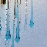 An ancient chandelier with blue tassels