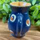 Small blue ceramic jug with hand-painted floral decoration, vintage.