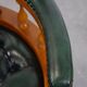 Classic green leather Chesterfield office chair on wheels.