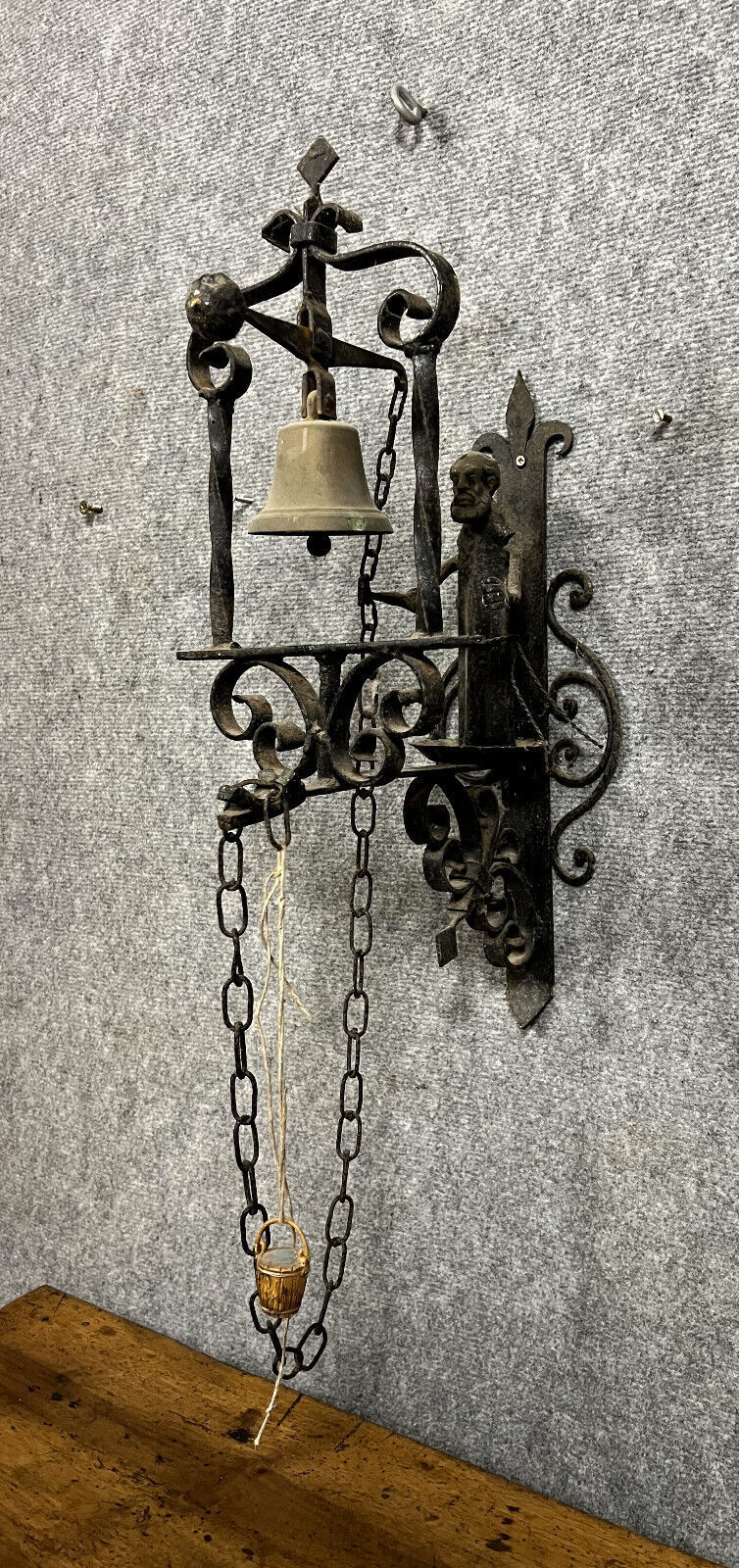 Wrought iron entrance bell depicting a monk ringing a bell circa 1900-1930