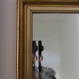 Large beveled mirror in carved wood