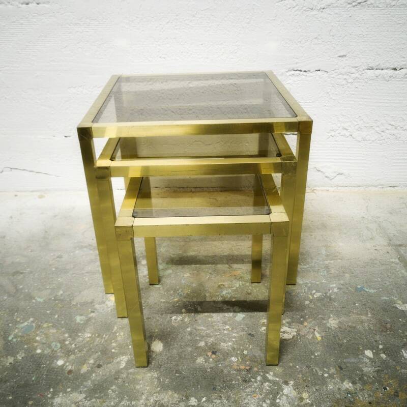 Trio of nesting tables in brass and smoked glass