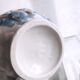 Small ceramic pitcher decorated with grapes