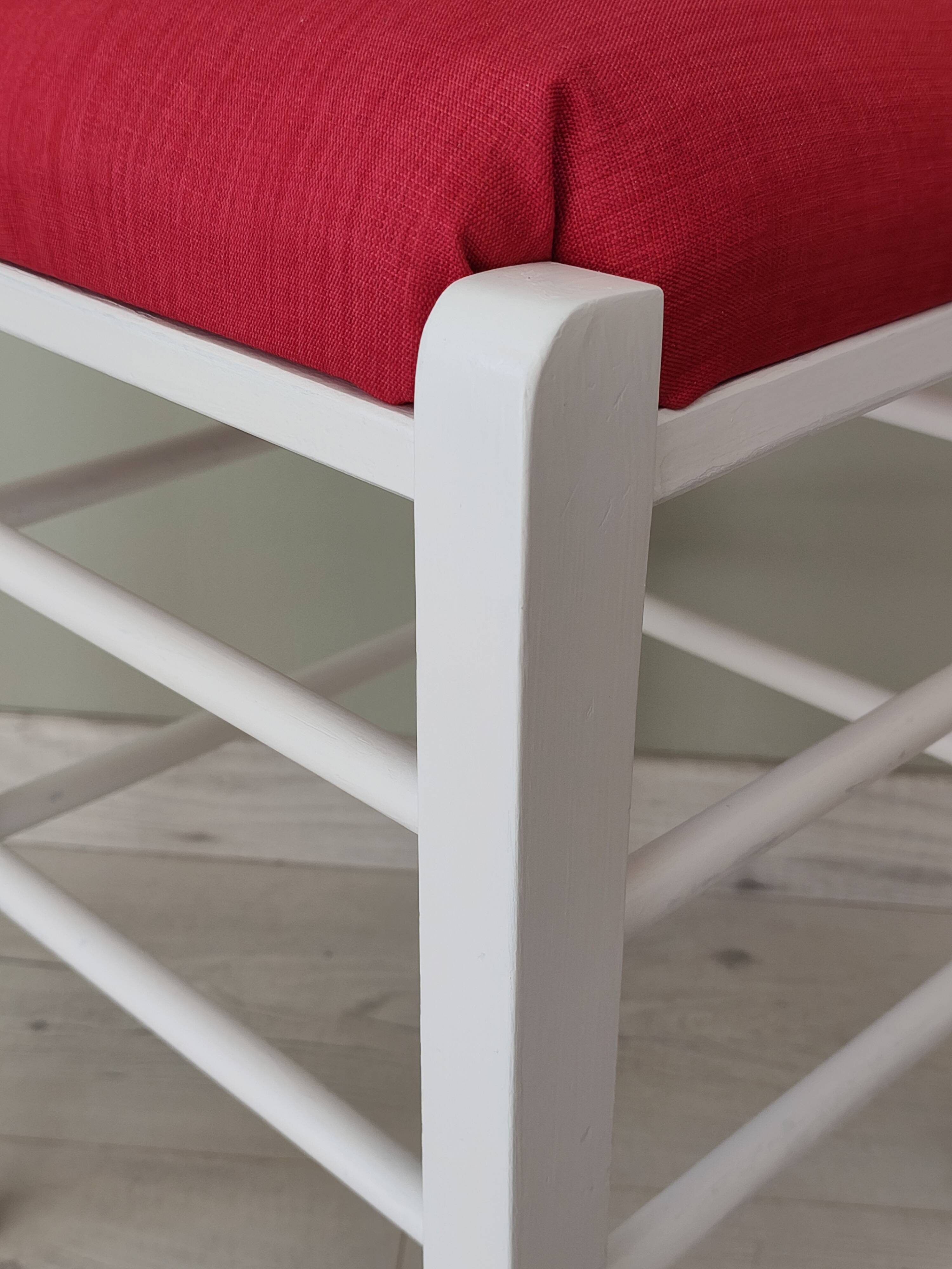 White pine stool with a red seat.