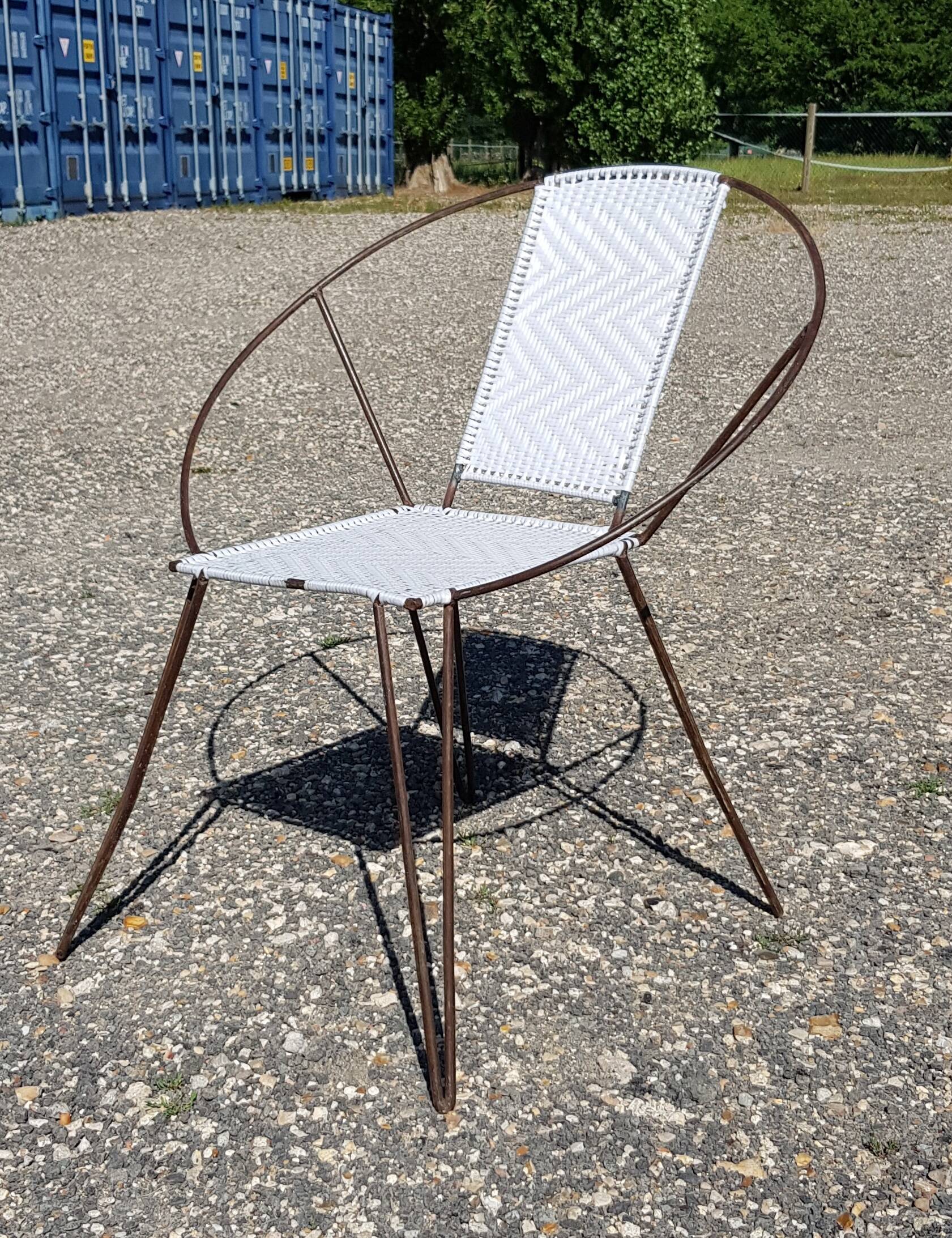 Vintage armchair in black metal and white plastic caning.