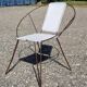 Vintage armchair in black metal and white plastic caning.
