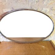 Oval Art Deco mirror with vintage chrome frame from the 1970s.