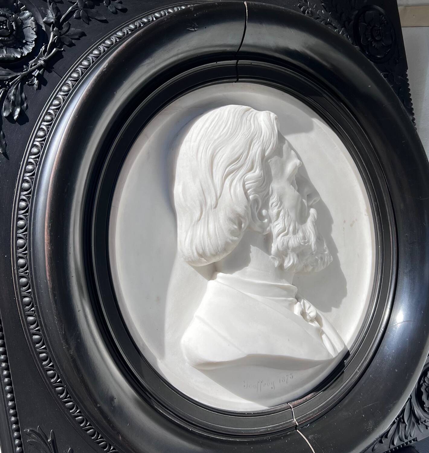 Bas-relief in marble and carved ebony signed Jouffroy, 1873