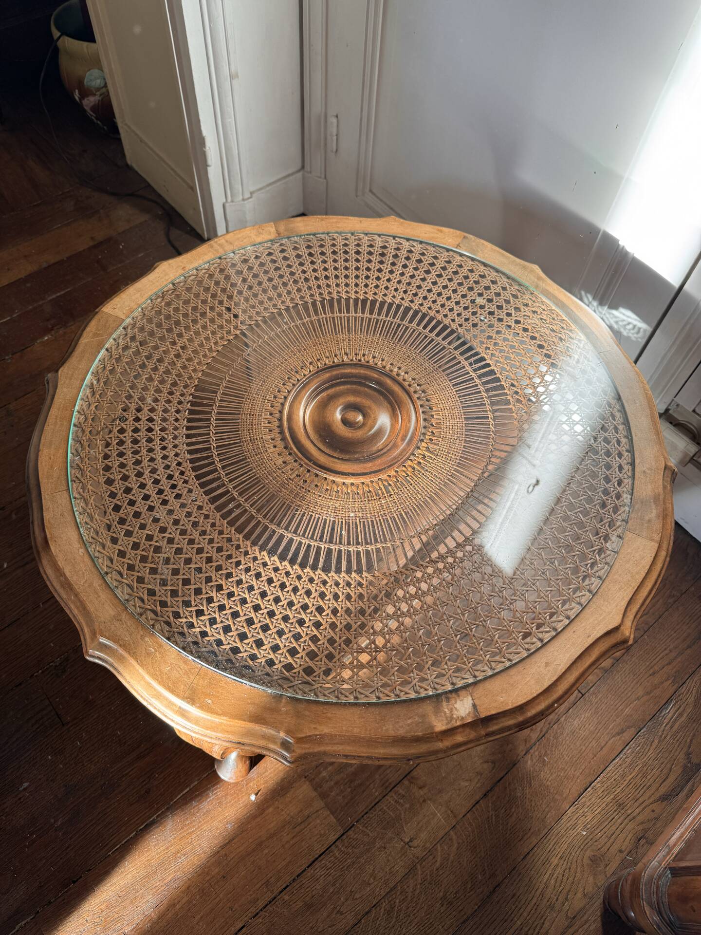 Round coffee table in Louis XV style, with sun cane and glass top.