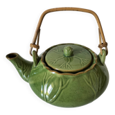 Vintage green teapot with lotus decoration and bamboo handle.