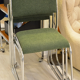 Chrome metal sled chair with green fabric