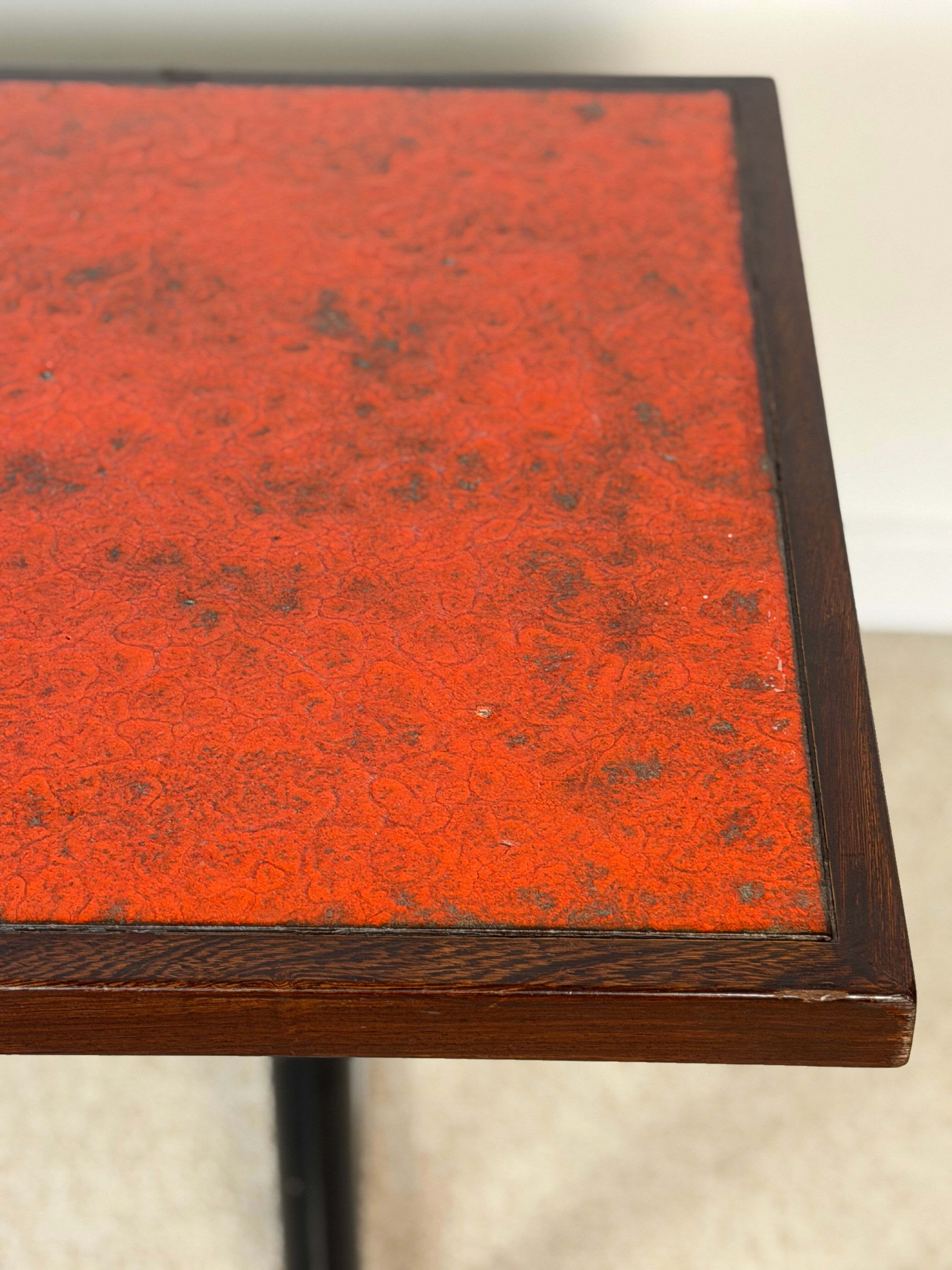 Vintage bistro table with orange-red ceramic.