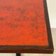 Vintage bistro table with orange-red ceramic.