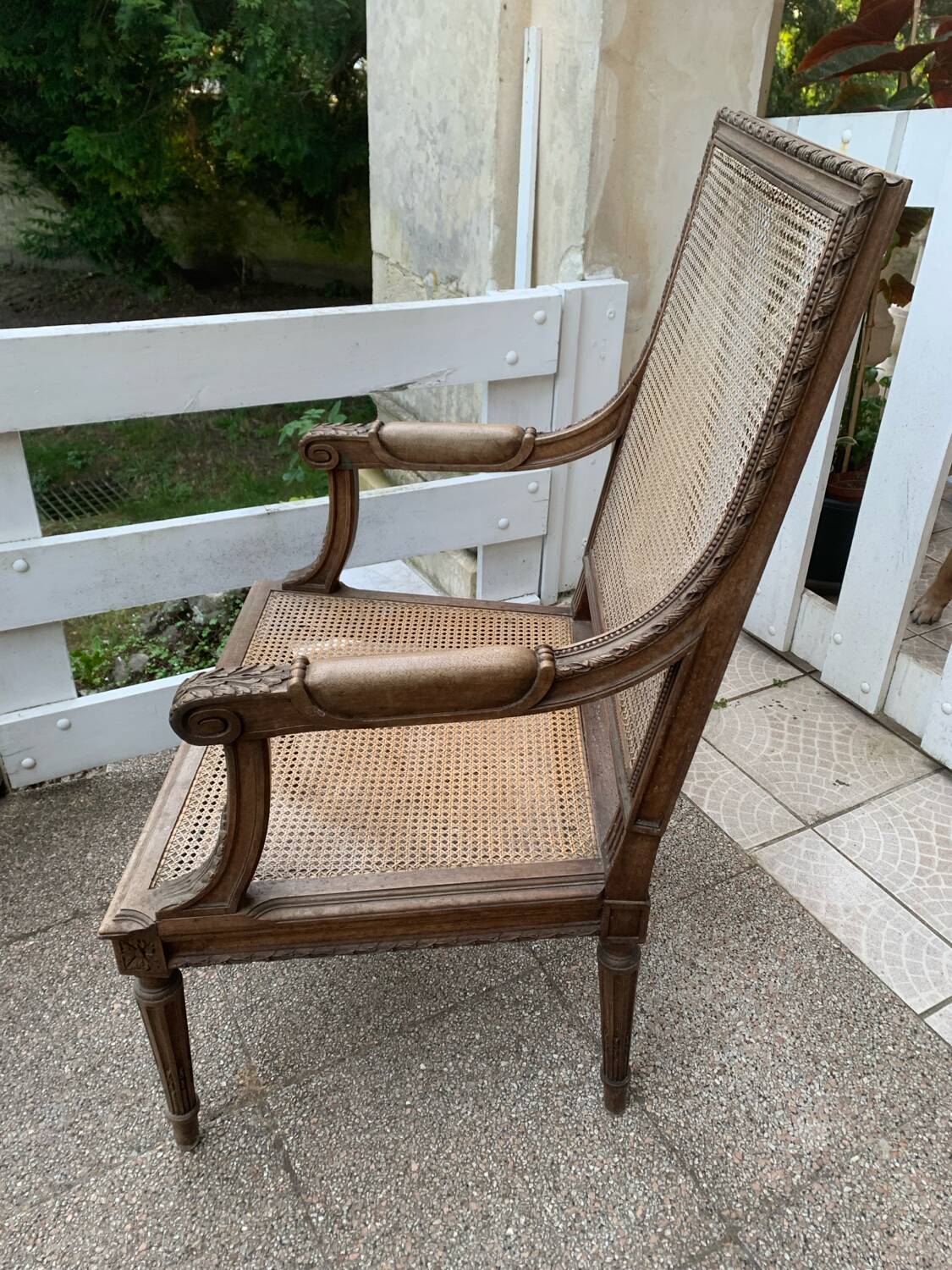 Wooden armchair with caning in Louis XVI style