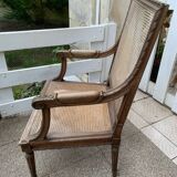 Wooden armchair with caning in Louis XVI style