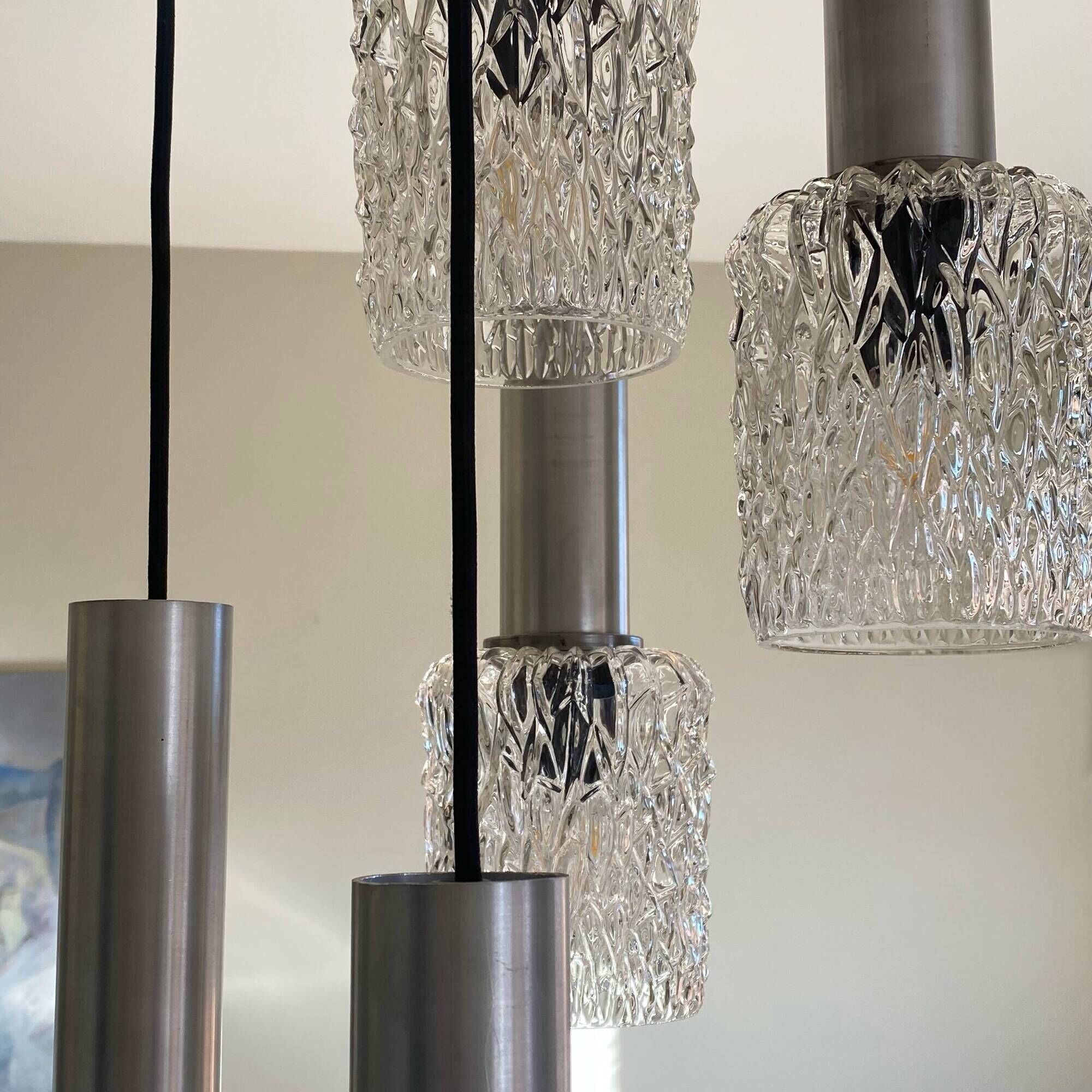 Large cascading chandelier with 5 glass lampshades and aluminium tube.