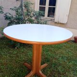 Round table in white formica and wood