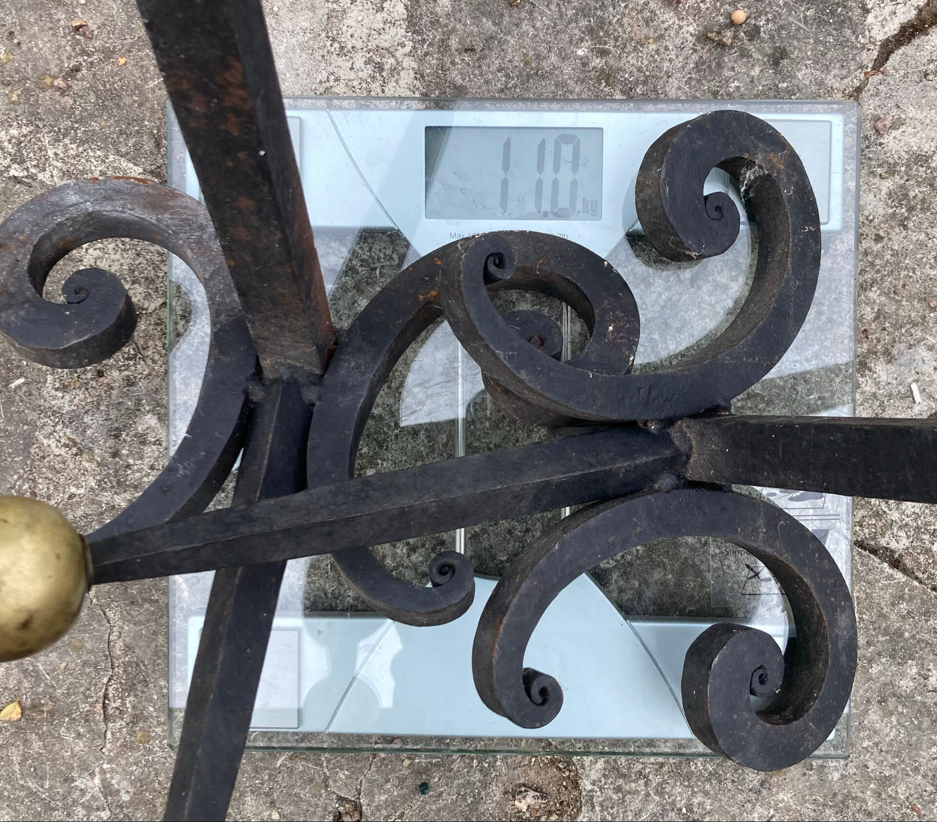 Massive wrought iron chenets from the 19th century topped with brass balls.