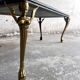 Vintage coffee table with a green marble top and gold legs.