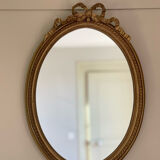Golden oval mirror with knot