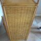 Storage column, wooden bookshelf and woven rattan.