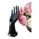 Hand holds black jewelry, ring sizer, soliflore, vintage French, 50s