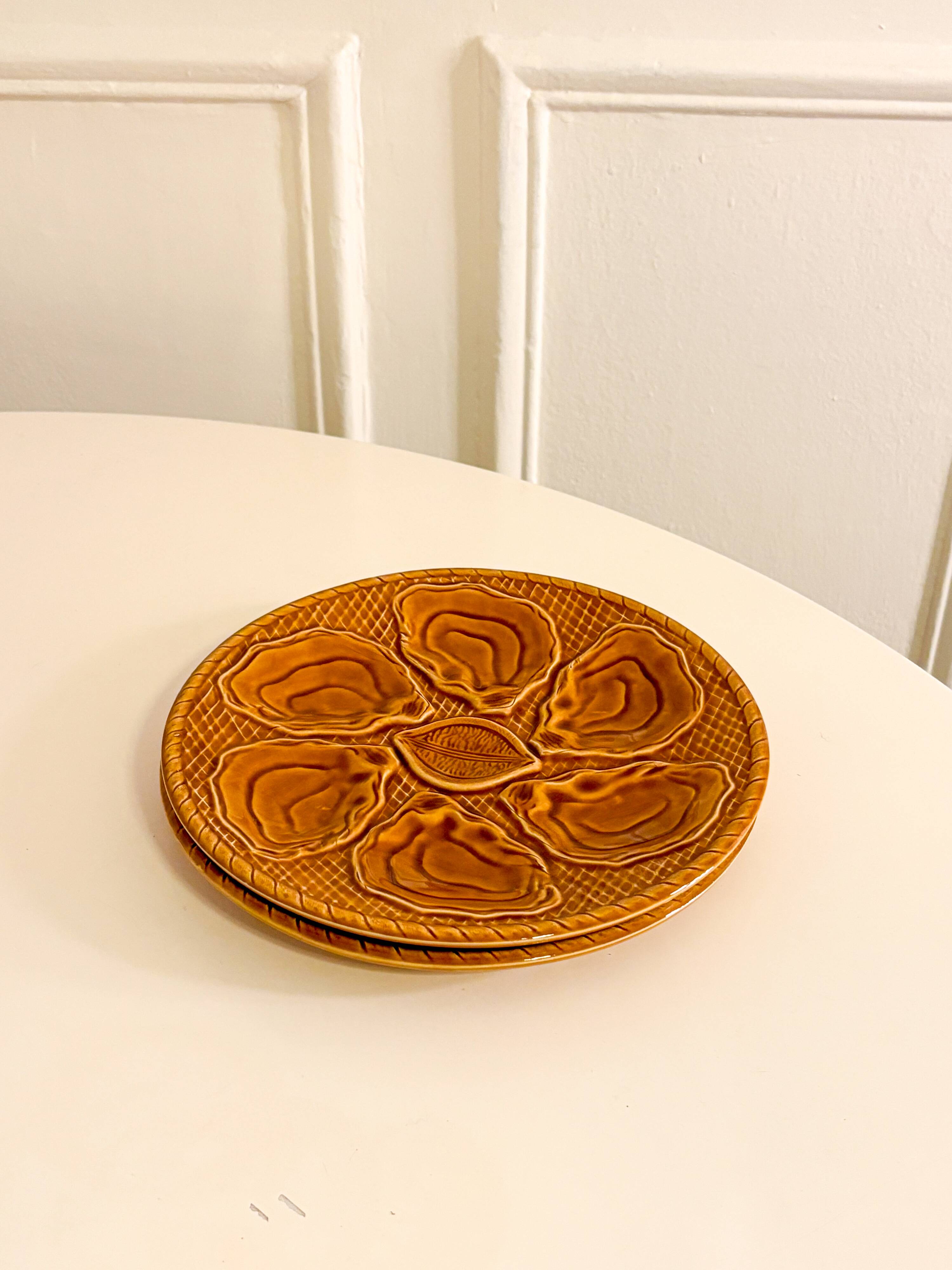 Pair of slip oyster plates, Brown, 1960