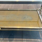 Coffee table in brass, brushed steel, glass, and gilded eglomisé mirror from Maison Jansen.