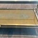 Coffee table in brass, brushed steel, glass, and gilded eglomisé mirror from Maison Jansen.